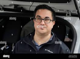 Tim Miranda, a software company manager currently working from home during  the coronavirus outbreak, sits in his vehicle outside his Chelmsford, Mass.  home, Thursday, April 2, 2020. Miranda, who usually works about