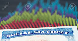 social security card in the usa laid on top of charts and graphs