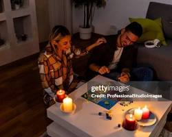 Image of person enjoying a candlelit dinner during a power outage in LA