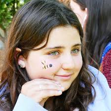 Dean of Students Willow Joffee and Dean of Residential Life Krisken  Lewis-Coward hosted a pop-up spirit festival and dance party at the Peace  pole. Students were able to get vibrant 'tattoos', have