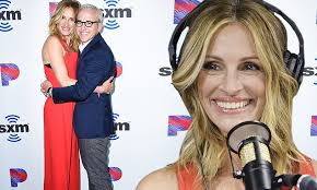Julia Roberts is ravishing in red overalls as she poses with host Jess Cagle  at SiriusXM interview