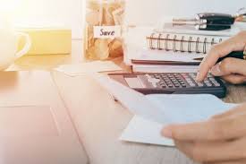 Home Office Expenses Concept Man Using Calculator On Desk With Hand Holding Bank Book And Coin In Bank Saving Premium Photo