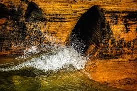 Waves crash against rugged rock ...