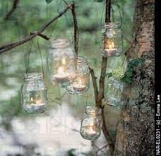 Recycled Glass Jam Jars Reused As Candle Holders Hanging From Tree Branches In A Wooded Garden Mason Jar Lanterns Jar Lanterns Hanging Jars