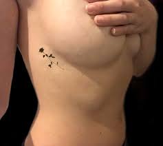 It resembles the thread painting technique where you drop paint on a piece of paper and use a thread to get interesting patterns. Under Breast Tattoos