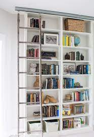 Custom built bookcases with adjustable shelving , center base doors and flat panel corner detail. Billy Bookcase Hack With Library Ladder The Lilypad Cottage