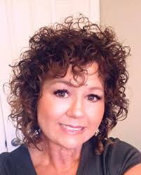 Age 50 widowed naturally curly hair!!! now 55, wearing it longer in front  shorter in the ￼back with natural curls!!!it's not about the hair but all  about the the perfect stylist Jennifer