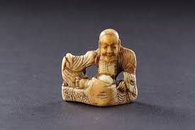 This ivory netsuke is in the form of tanuki, carrying his grossly enlarged scrotum. Early Japanese Ivory Netsuke Of A Rakan Or Arhat Early Japanese Ivory Netsuke Of A R Finch Co
