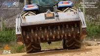 FAE STC200DT PTO stone crusher machine behind New Holland tractor crushing  rocks in apple orchards