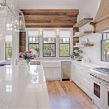 Modern Rustic Kitchen Design With Farmhouse Charm Featuring A Rough Hewn Wood Plank Wal Modern Farmhouse Kitchens Farmhouse Kitchen Design Beach House Kitchens