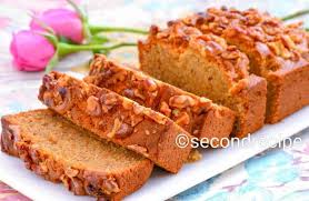 The cake is topped with walnuts. Eggless Banana Walnut Cake