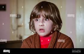 USA. Danny Lloyd in a scene from the (C)Warner Bros film: The Shining  (1980). Plot: A family heads to an isolated hotel for the winter where a  sinister presence influences the father