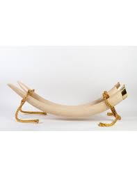 Originally sculpted of authentic ivory elephant tusks, the remarkable replica is exclusively created for the design toscano in faux mandarin ivory, a polymer blend capturing the coveted antique patina and intricate sculpts. Resin Coffee Table Imitation Elephant Tusks Gold Bronze 1960