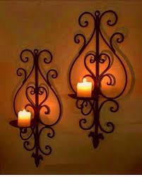 Wall sconces that work as candle holders have the benefits of being less inexpensive in that you aren't using power and purchasing batteries. Wall Sconces Candles Wrought Iron Ideas On Foter