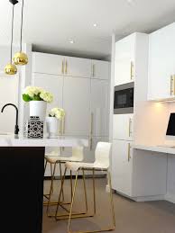 New paint gives your cabinets a facelift that updates and refreshes your whole kitchen. Black White Kitchen With Brass And Gold Accessories High Gloss Cabinets Gold Brass Pendant Li Kitchen Bar Stools Modern Kitchen High Gloss Kitchen Cabinets