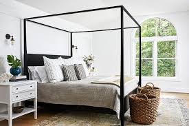 Discover unique white bedding at anthropologie to complete your bedroom. Black Wood Canopy Bed With White Nightstands Transitional Bedroom