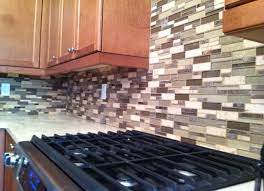 Use a tile cutter to even out the end of your mosaic tile pieces on the edge that you plan to start and then place it atop the tile edging and gently press the tile into the mortar. Glass Stone Mosiac Kitchen Backsplash Tile Install By Don Of All Trades