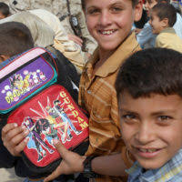 Builder 2nd Class Richard L. Liles Jr., from U.S. Naval Mobile Construction  Battalion (NMCB) 26, talks with his son about his time