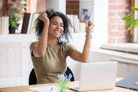 Excited African American Woman Sit At Desk Feel Euphoric Win Stock Photo Picture And Royalty Free Image Image 137895143