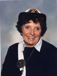 A street is rededicated for a cowbell-ringing crossing guard. She would  have turned 100 this year