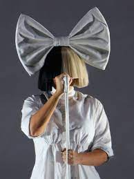 Why Does Sia Cover Her Face With A Wig Here S The Answer Allure Around the release of her fifth album, we are born, sia began to get uncomfortable with her growing fame. why does sia cover her face with a wig