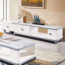 Sleek, modern television stand and coffee table are matched by an occasional table and storage cabinet. China High Quality Living Room Casual Style Hollow Design Modern Wood White Tv Stands Furniture Tv Stand Coffee Table Set China Tv Stands Wood Furniture Tv Stand White