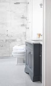 Marble bathrooms marble continues to be one of the biggest bathroom trends this year. Beautiful Bathroom Features A Dark Gray Vanity Topped With Carrera Marble Atop A White Marble He Herringbone Tile Floors Bathrooms Remodel Marble Tile Bathroom