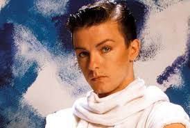 Ricky Gervais AS A POP singer in the 1980s.