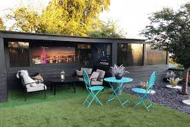 Put down a decorative outdoor rug to define a seating and dining area. Custom Made Covered Seating Area With Integrated Bbq Dig In Landscaping