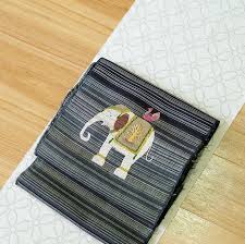 紬帯に日本刺繍 夏白大島 少しとぼけた感じの象の上にピンクの鳥が止まった帯 細かな相良刺繡が施されています 着物には シンプルな七宝柄 夏糸を使った大島紬 透け感とシャリ感が両立した風合いが 素敵です お腹部分は紬の横段だけなので 効き色 pot