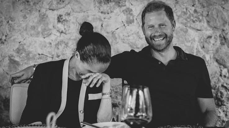 Prince Harry and Meghan Markle holding hands near Falkland Arms pub
