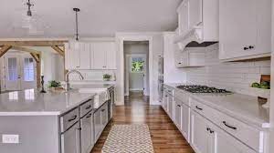 Brown granite countertops also take away the starkness of white kitchen cabinets and highlights the warmth of a space. White Shaker Kitchen Cabinets With Quartz Countertops Youtube