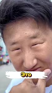 Asian Guy Looking at Coat Funny