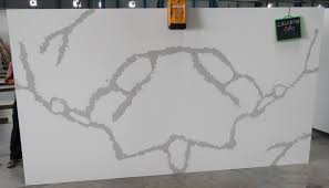 Featuring unique movement and patterns making each slab the most natural looking surface available. Calacatta Oro White Quartz From India Quartz Stone Slabs