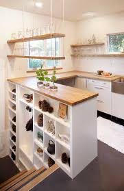 Small Kitchen With Smart Stairwell Shelving No Upper Cabinets Visible Anyway In 2020 Kitchen Remodel Small Stairs In Kitchen Kitchen Remodel Countertops