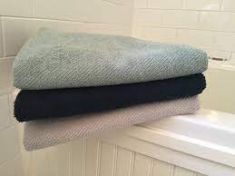 She spread a bath towel over a chair, moved another chair near, put out various articles of clothing, and left the room again. Making Sense Of Buying Bath Towels Atticmag