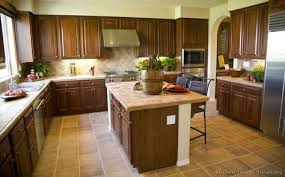 This kitchen intelligently creates different zones using blocks of white and dark cabinets at opposite ends of the kitchen. 67 Golden Brown Kitchens Ideas Brown Kitchens Kitchen Design Kitchen Pictures