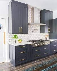 The tile backsplash behind the oven is a geometric marble with metallic inlay which creates a glamorous patterning. Kitchen Ideas Dark Cabinets Modern Floors Full Size Of Kitchen45 Charming Navy Blue Kitchen Ideas Kitchen Cabinet Design Navy Kitchen Cabinets Kitchen Remodel