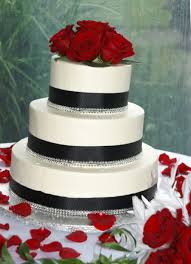 Black And White Wedding Cakes With Bling A Beautifully Elegant White Wedding Cake Embellished With Roses And Black Ribbon With Added Diamond B White Wedding Cakes Wedding Cakes Special Occasion Cakes