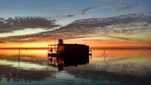 The lakefront cabins each have a fire ring to build a cozy fire and pedal boats for a ride around the lake. Laguna Adventures Floating Cabin Rental Baffin Bay Floating Cabin