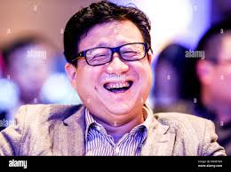 FILE--William Ding Lei, CEO of NetEase (163.com), laughs during the NetEase  Annual Economist Conference in Beijing, China, 16 December 2014. As pa  Stock Photo