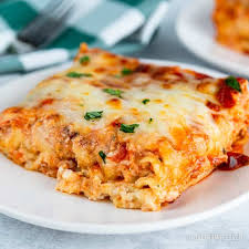 Slice Of Lasagna On A White Plate With A Green And White Napkin And Fork In The Background In 2020 Easy Lasagna Recipe Easy Lasagna Easy Cheese Lasagna Recipe