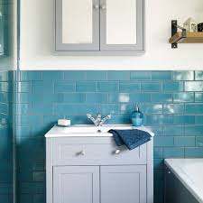 The bathroom set has a waterproof shower curtains. Teal Blue Bathroom Makeover With Patterned Floor And Grey Furniture