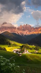 If you're looking for the best mountains wallpaper then wallpapertag is the place to be. Dolomites Mountains Village Clouds Italy 750x1334 Iphone 8 7 6 6s Wallpaper Background Picture Image