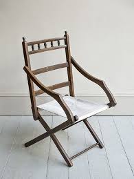 An Edwardian Collapsable Campaign Chair With Cross Frame And Canvas Seat The Ladder Back With A Spindle Gallery And Turned Chair Outdoor Chairs Library Chair