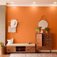 The fiery orange wall creates a dramatic effect as. Try Dusky Saffron House Paint Colour Shades For Walls Asian Paints