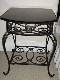 This table features a solid round top, a small storage drawer and solid legs that provide stability. Decorative Wrought Iron Bedside Table W Black Marble Top Wrought Iron Bedside Tables Iron Bedside Table Wrought Iron Furniture