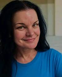 Basset hound destroying oven mitt