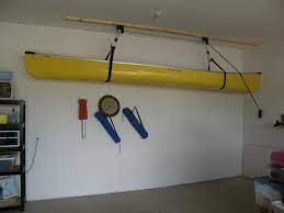 Try cutting two 50 feet cords then tie the boat hooks to the both cords. Garage Cabinets Minneapolis Garage Shelving St Paul Mn Kayak Storage Diy Kayak Storage Garage Ceiling Storage