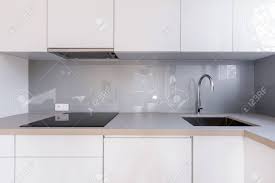 white kitchen with gray backsplash